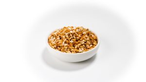 Vita-Pakt Grapefruit Dried Peel granules in a white bowl on a white background